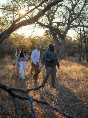 a group of people walking in a field at Ukanyi Private Luxury Villa in Hoedspruit
