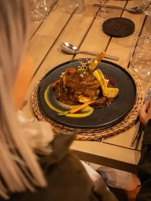 a plate of food with french fries on a table at Ukanyi Private Luxury Villa in Hoedspruit