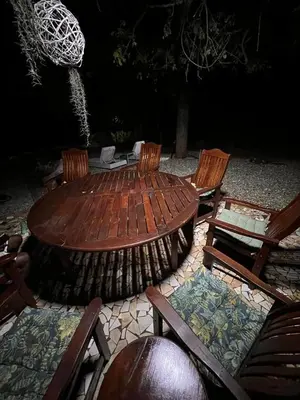 a wooden table and chairs in a patio with a table and chairs at The Castello at Kruger in Marloth Park
