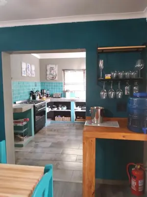 a kitchen with blue walls and a wooden counter top at 4609 Ratel in Marloth Park