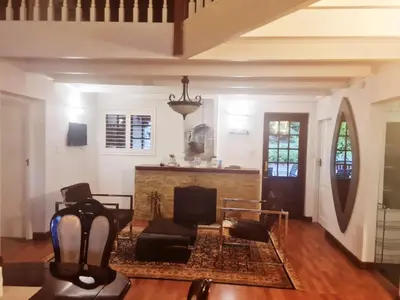 a living room with a fireplace and a chair at 147@ Simon Bekker Kosmos in Hartbeespoort