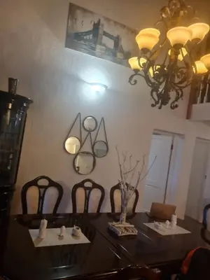 a dining room with a table with chairs and a chandelier at 147@ Simon Bekker Kosmos in Hartbeespoort