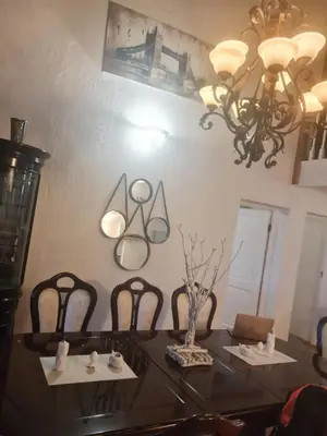 a dining room with a table with chairs and a chandelier at 147@ Simon Bekker Kosmos in Hartbeespoort
