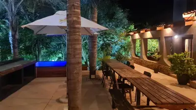 a patio with a table and an umbrella at The Captain in Pretoria