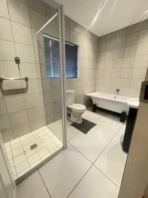 a bathroom with a shower and a toilet and a sink at Priceless Cove. Garden Cottage in Midrand