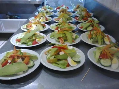 a row of plates of food on a table at Sidze Guest House in Polokwane