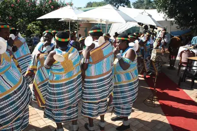 a group of people dressed in costumes standing under umbrellas at Sidze Guest House in Polokwane