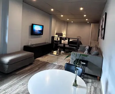 a living room with a table and a couch at Waterkloof Nature Reserve Studio Apartment in Pretoria