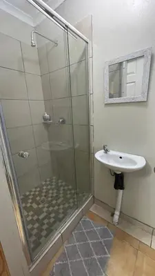 a bathroom with a shower and a sink at Blue Haven Guesthouse in Polokwane