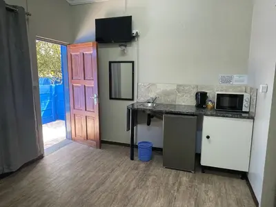 a kitchen with a counter top and a microwave at Blue Haven Guesthouse in Polokwane
