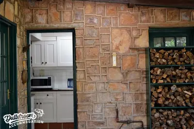 a kitchen with a brick wall and a doorway at Critchley Common 24 in Dullstroom