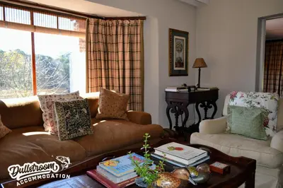 a living room with a couch and a table at Critchley Common 24 in Dullstroom
