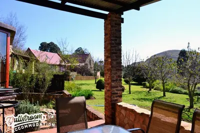 a patio with a table and chairs in a yard at Critchley Common 24 in Dullstroom