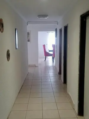 a hallway with a table and a chair in a room at eManzini Guesthouse in Matibidi