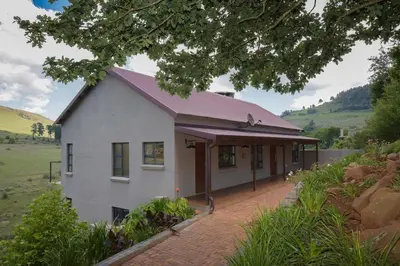 a white house with a purple roof at Walkersons Riverview in Dullstroom