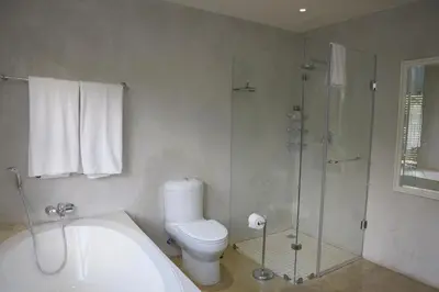 a bathroom with a toilet and a glass shower at Walkersons Riverview in Dullstroom