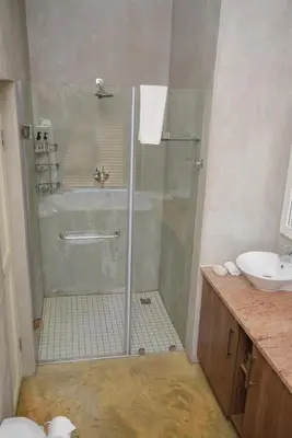 a bathroom with a shower and a sink at Walkersons Riverview in Dullstroom