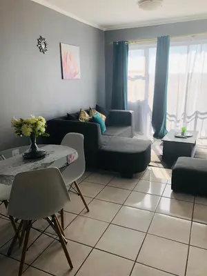 a living room with a couch and a table at Menlyn Comfort in Pretoria
