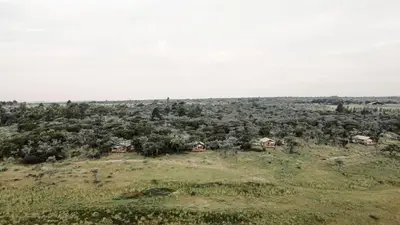 an aerial view of a field with houses and trees at AfriCamps Waterberg in Vaalwater