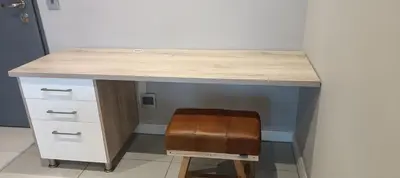 a desk with a wooden counter top and a brown stool at Menlyn Maine Trilogy Apartment 808 in Pretoria