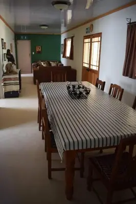 a dining room with a table and chairs and a couch at Waterberg Hideaway in Thabazimbi