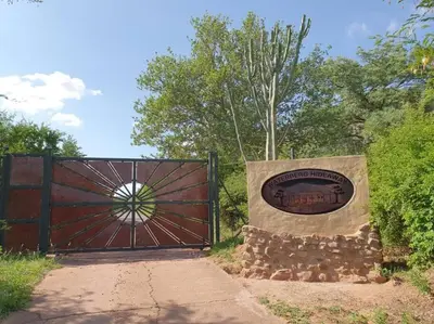 a gate with a sign in front of it at Waterberg Hideaway in Thabazimbi