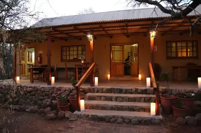 a house with a staircase and lights in front of it at Waterberg Hideaway in Thabazimbi