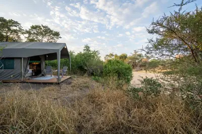a tent in the middle of a field at Kruger Untamed - Tshokwane River Camp in Skukuza