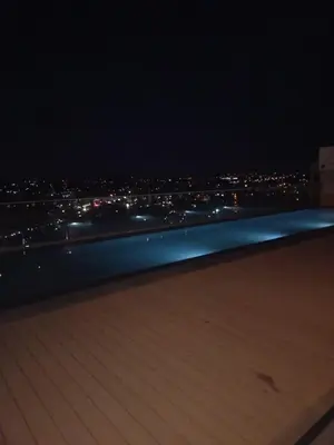 a view of a city at night from a rooftop at Menlyn Maine Trilogy Apartment 509 in Pretoria