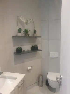 a white bathroom with a toilet and a sink at Menlyn Maine Trilogy Apartment 509 in Pretoria
