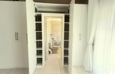 a bathroom with a closet with a toilet in it at The Dream Guesthouse in Ermelo