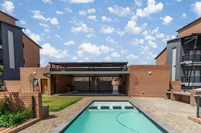 a swimming pool in the backyard of a house at Smart apartment 322 in Midrand