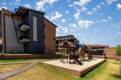 a playground in front of a building at Smart apartment 322 in Midrand