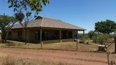 a house on the side of a dirt road at Matalatala Wildlife Lodge in Roodeplaat