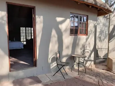 a table and chairs in front of a building at Matalatala Wildlife Lodge in Roodeplaat
