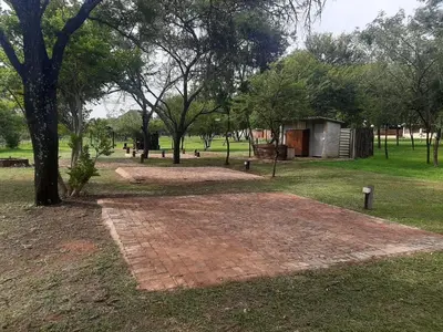 a brick walkway in a park with a building at Matalatala Wildlife Lodge in Roodeplaat