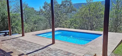 a swimming pool sitting on top of a patio at Loskop Serene Bush Cabin in Winterkamp