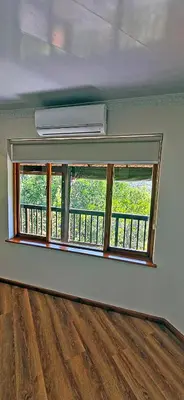 an empty room with a window and a balcony at Loskop Serene Bush Cabin in Winterkamp