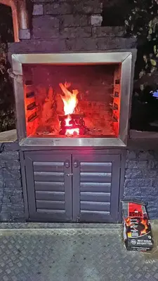 a fireplace with a fire in it at Loskop Serene Bush Cabin in Winterkamp