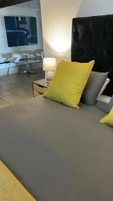 a bedroom with a bed with yellow pillows at Loskop Serene Bush Cabin in Winterkamp