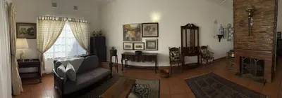 a living room with a couch and a fireplace at Palm House Accomodation in White River