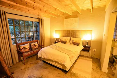 a bedroom with a bed and a large window at SouthernCross@Kruger in Marloth Park