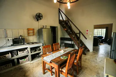 a kitchen with a table and chairs and a staircase at SouthernCross@Kruger in Marloth Park