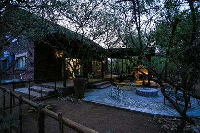 a house with a patio with a fountain in the yard at SouthernCross@Kruger in Marloth Park