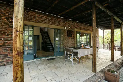 a patio with a table and a brick building at SouthernCross@Kruger in Marloth Park