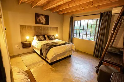 a bedroom with a large bed and a window at SouthernCross@Kruger in Marloth Park