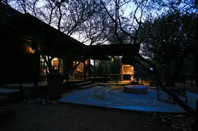 a park with a bench and a tree at night at SouthernCross@Kruger in Marloth Park