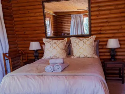 a bedroom with a bed with two towels on it at Moopong Farm House in Dullstroom