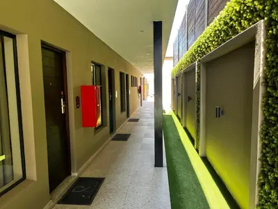 an empty hallway of a building with green plants at Riverleaf Hotel in Brits