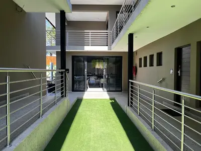 an empty hallway with green grass in a building at Riverleaf Hotel in Brits